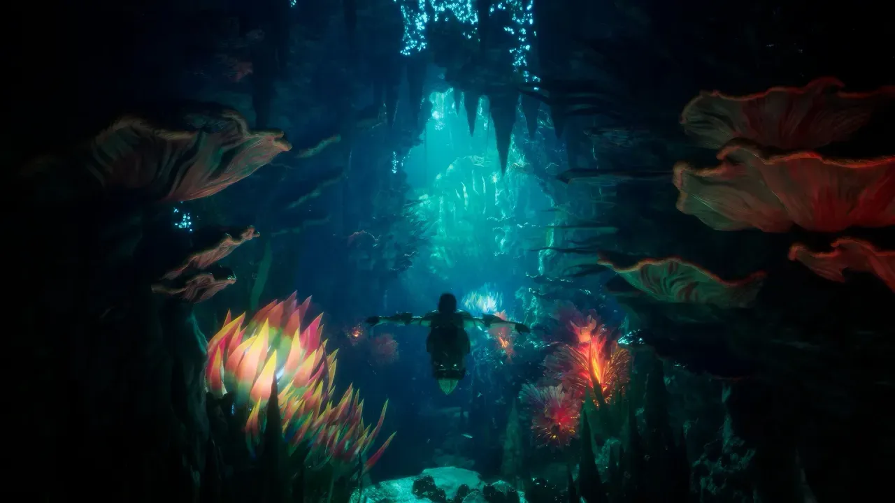A character swims through a dark underwater cave lit by glowing coral-like plants